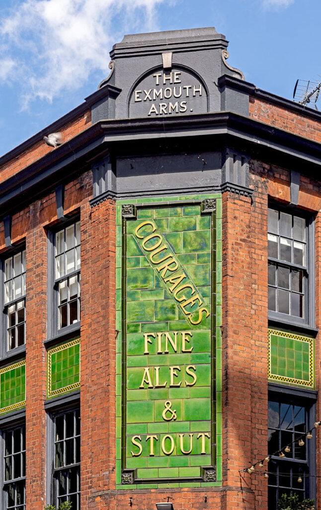 Exmouth, Clerkenwell: Tiled 'Courages' corner sign