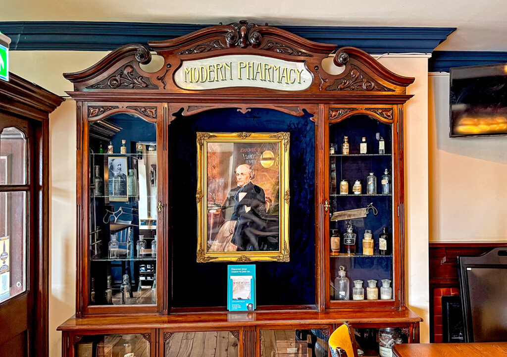 Dr Duncans, Liverpool: Pharmacy cabinet with painting of Dr Duncan in centre