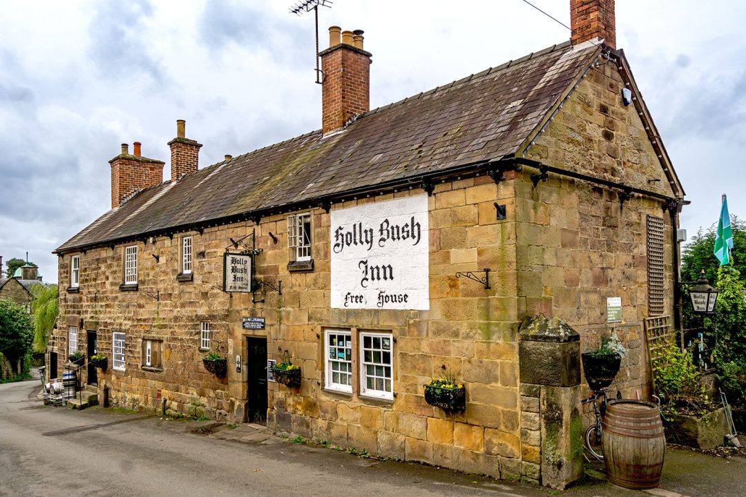 Holly Bush, Makeney: Exterior of long golden stone long building with slate roof