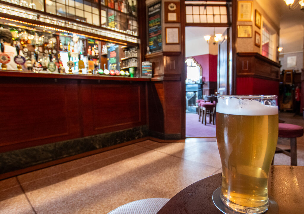 Swan, York: Lobby with close-up pint glass on a table