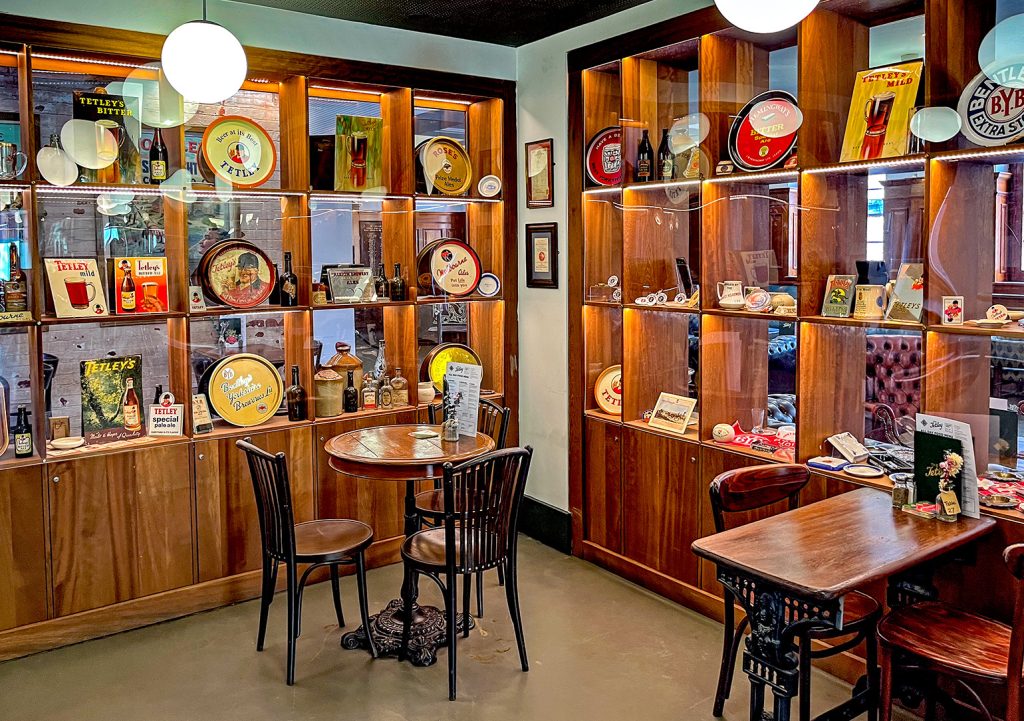 Tetley Pub, Leeds: Tetley corner - wood and glass cabinets with Tetley Brewery memorabilia