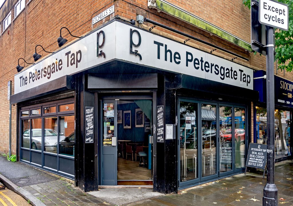 Petersgate Tap, Stockport: Exterior, a blue and black painted corner shopfront with white pub name signs