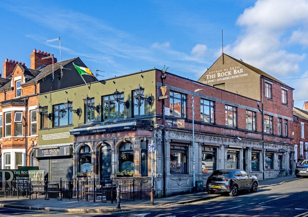Rock, Belfast: Grey painted exterior with old carved signs