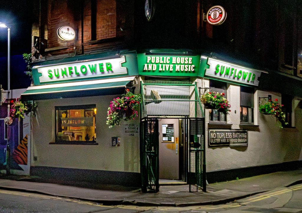 Sunflower, Belfast: Close-up of exterior at night with gated security entrance, a relic of the troubles
