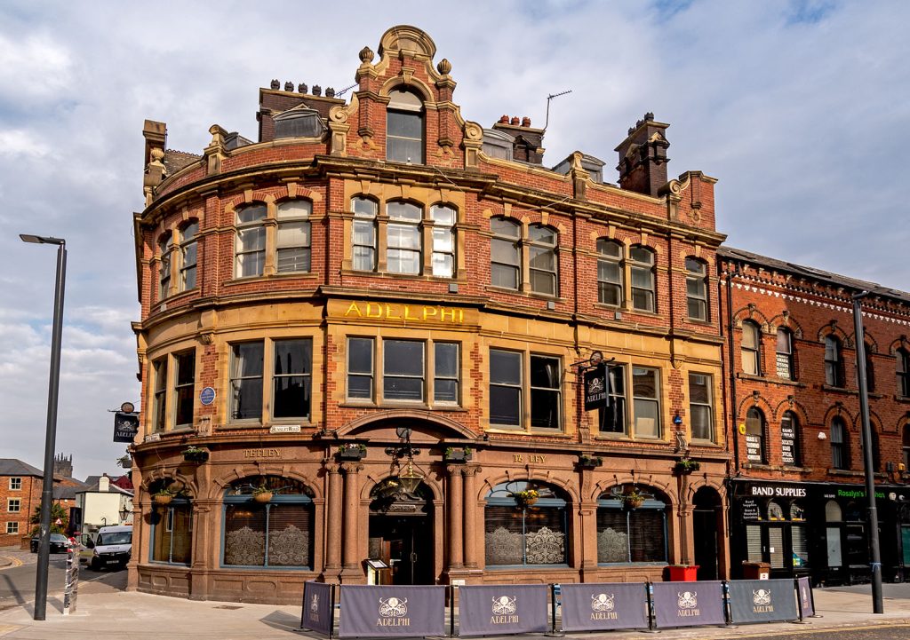 Adelphi, Leeds: Stone and red brick curved exterior of large corner pub