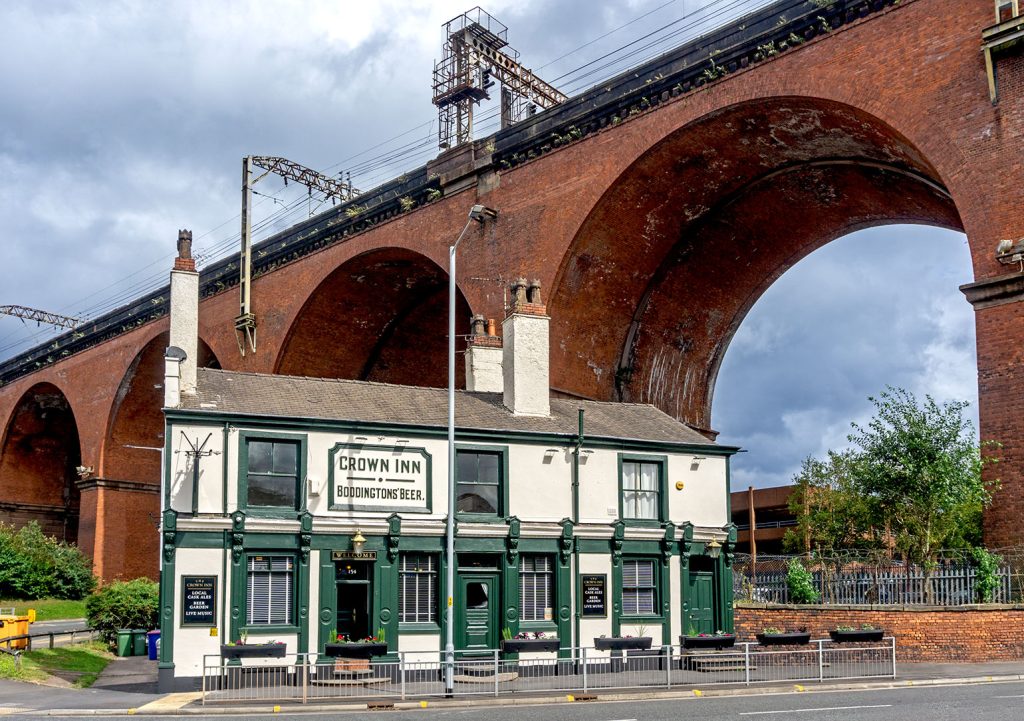 Crown, Stockport: Green and white painted exterior with viaduct above