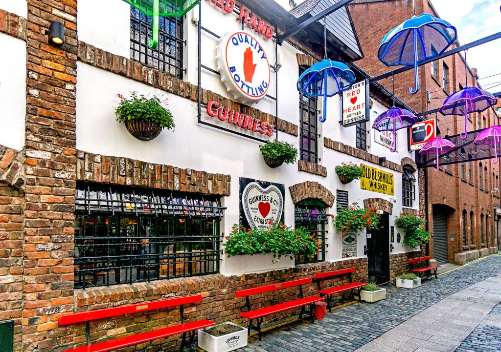 Duke of York, Belfast: South side, white painted and red brick exterior with brewery signs on the wall.