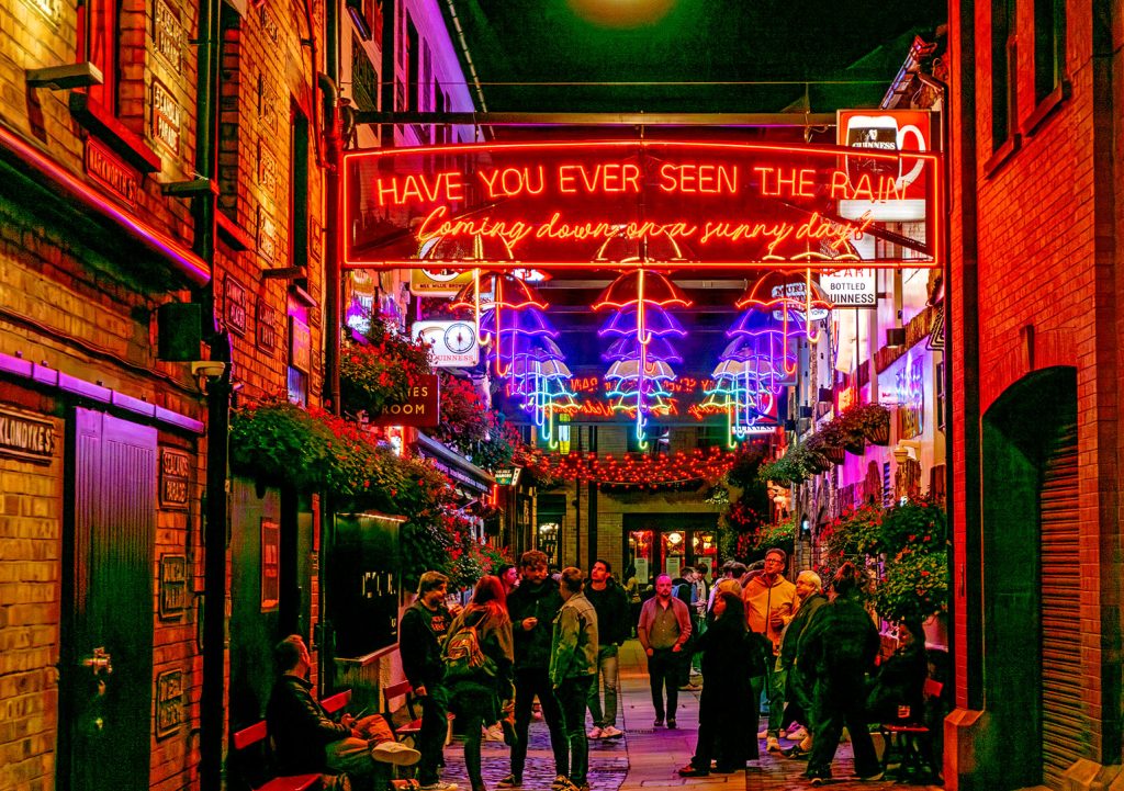 Duke of York, Belfast: Exterior at night with customers in street and neon signs
