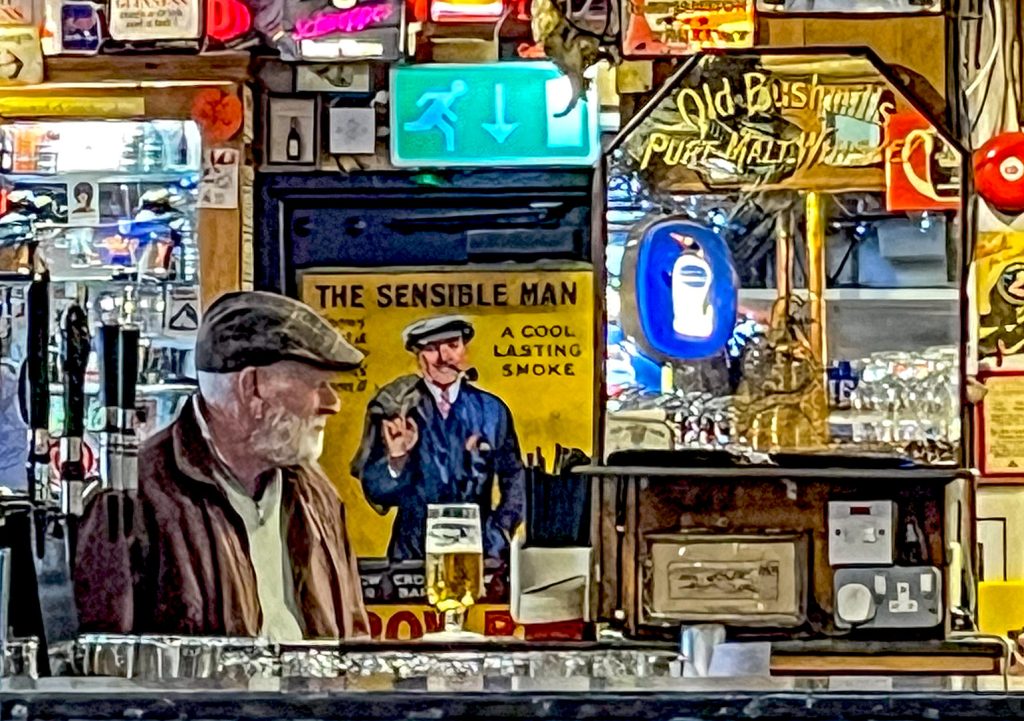 Duke of York, Belfast: Older customer at the bar wearing a flat cap with cigarette advert behind showing man in flat cap