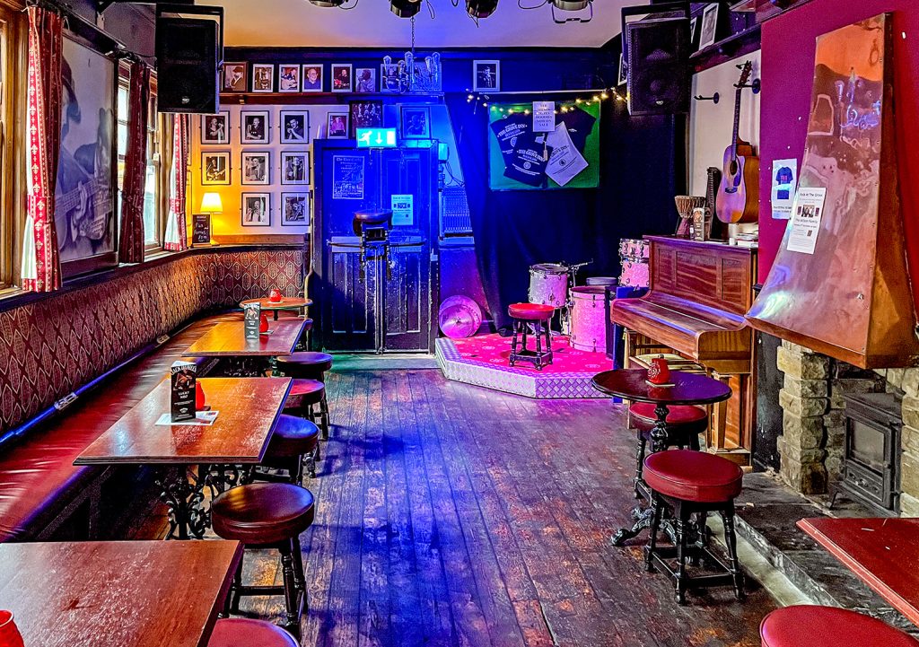 Grove Inn, Leeds: Concert Room with seating, stage and piano