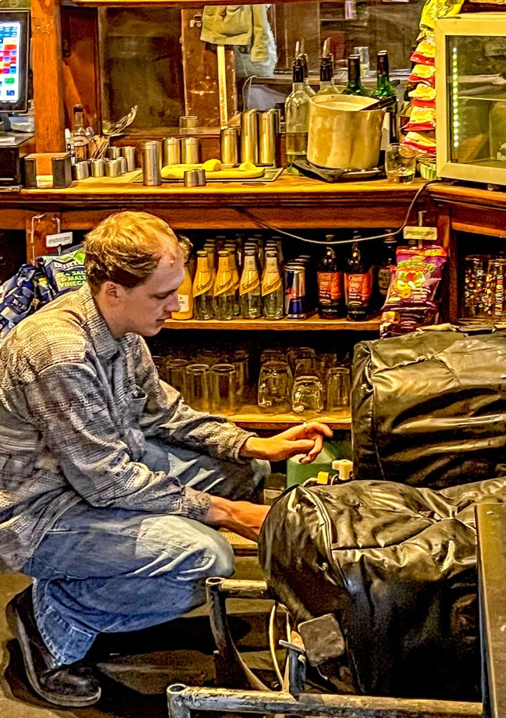 A member of bar staff pouring Bass from a cask into a jug