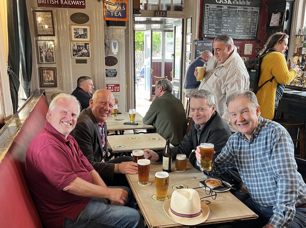Station Buffet, Stalybridge: Pub interior with four elderly men grinning at the camera