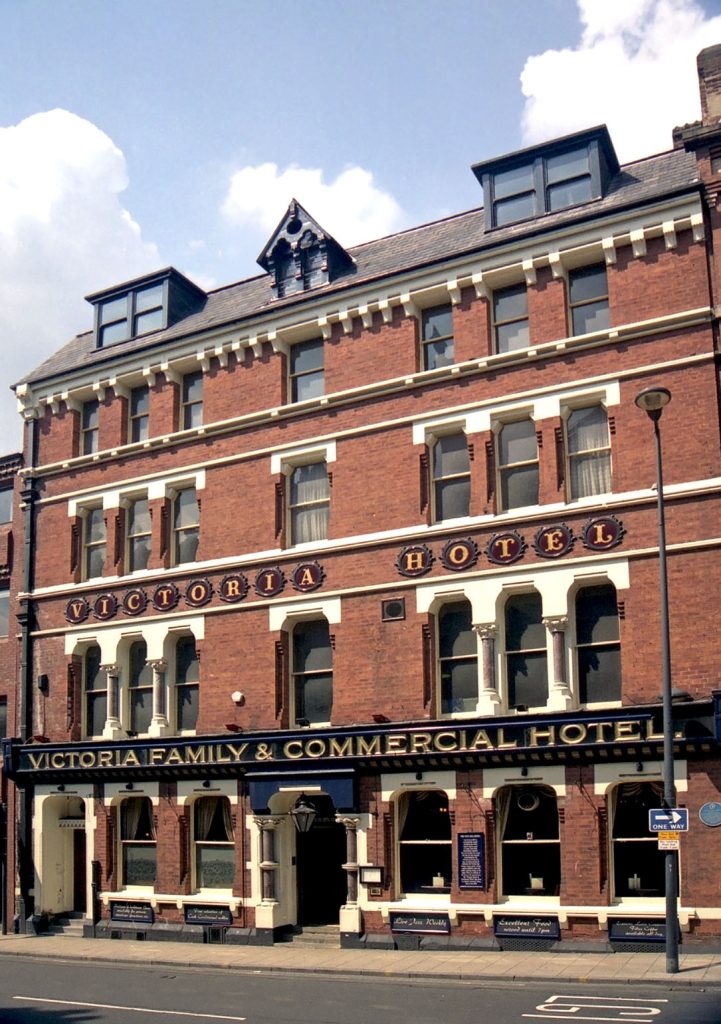 Victoria Hotel, Leeds: Four storey red brick exterior with 'Victoria Family & Commercial Hotel' sign