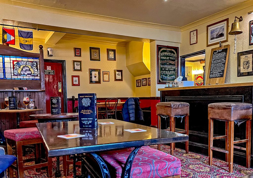 Alexandra, Norwich: Back room with carpet and pub furniture.