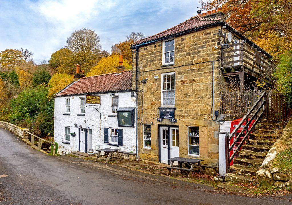 Birch Hall, Beck Hole: Pub exterior, a whitewashed 2 storey cottage next to a sandstone faced 3 storey house.